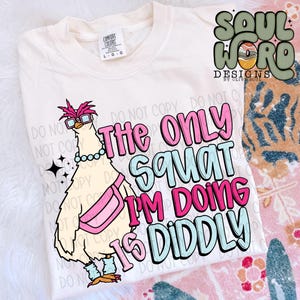 May include: A white t-shirt with a cartoon chicken wearing sunglasses and a pink fanny pack. The text "The only squat I'm doing is diddly" is printed on the shirt in pink, blue, and white.