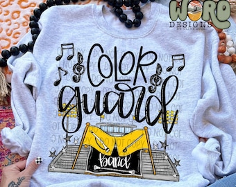 May include: Gray sweatshirt with a black and white graphic design that says "Color Guard" with musical notes and a marching band scene. The scene includes a stage, flags, and instruments.