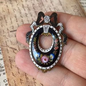 Romantic Antique Victorian pendant with black/white enameled ribbon and frame decorated with a beautiful floral motif
