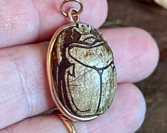 Vintage Egyptian revival steatite scarab pendant with a royal hunt scene hieroglyph on the back