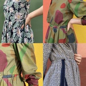 May include: Four dresses are displayed, each with a unique pattern. One features a floral design in green and white. Another has large, colourful shapes on a green backdrop. The third dress has a geometric pattern in blue and white. The fourth dress has a similar pattern.