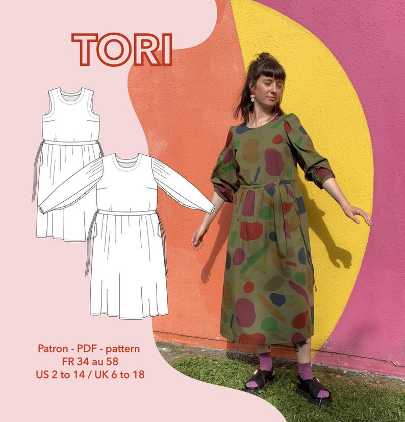 May include: A woman models an olive green dress with colourful abstract shapes against a bright wall. The dress features long sleeves and a gathered waist. The image also shows a dress pattern with the word "TORI". Text below indicates sizes, including UK sizes 6 to 18.