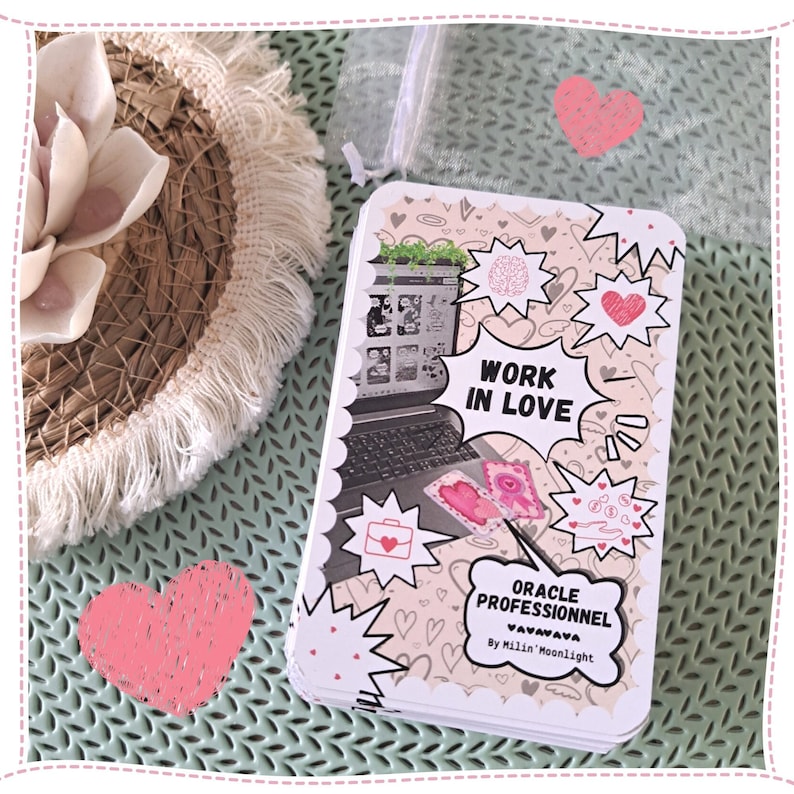 May include: A deck of oracle cards with a pink and white color scheme. The cards feature a cartoon style illustration of a laptop with the text "Work in Love" and the words "Oracle Professionnel Vavavava By Millin Moonlight".