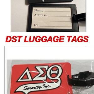 May include: Two luggage tags with a red and white logo that says "&Alpha;&Sigma;&Theta; Sorority. Inc." The tags are black and red. The black tag has a space for a name, address, and phone number.