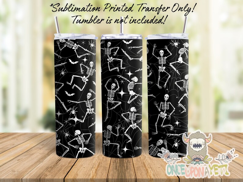 Sublimation print transfer for 20 oz skinny straight sided tumbler. Has a black background with dancing Skeleton Images and Spider Webs.