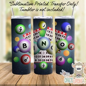 May include: Three sublimation printed transfer designs for a tumbler featuring a bingo theme. The designs feature a dark blue background with colorful bingo balls and bingo cards with numbers.