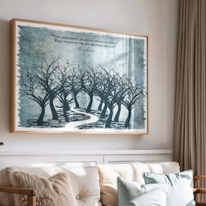 May include: A framed art print depicting a path through a forest of silhouetted trees in shades of blue and white. The artwork includes the text: "THE IMPEDIMENT TO ACTION ADVANCES ACTION. WHAT STANDS IN THE WAY BECOMES THE WAY." The frame is made of light-colored wood.