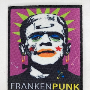 May include: A rectangular patch with a pop art style image of Frankenstein's monster. The monster has makeup, safety pin earrings, and a purple background with green rays. The text "FRANKENPUNK" is at the bottom.