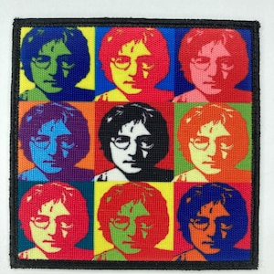 May include: A square patch with a pop art design of a man wearing glasses, repeated in a 3x3 grid. Each image has a different colour scheme, including blue, red, green, and yellow. The patch is bordered with a black edge.