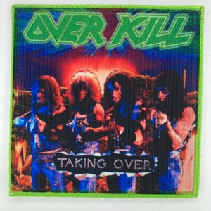 May include: A square fabric patch featuring a graphic of four band members with long hair. The text OVER KILL appears in green at the top, and the text TAKING OVER is printed on a white banner across the center. The patch has a bright green border.