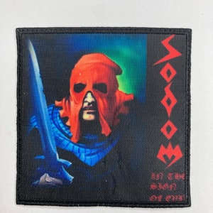May include: Square black patch featuring a warrior with a red helmet and a blue sword against a blue and green background. The word "Doom" is printed in red on the right side, with additional text below.