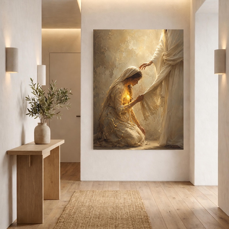May include: A vertical wall art print depicting a kneeling figure in a light-colored robe reaching out to touch the hem of a standing figure draped in flowing white fabric. The scene is rendered in warm, golden tones with a soft, ethereal glow.