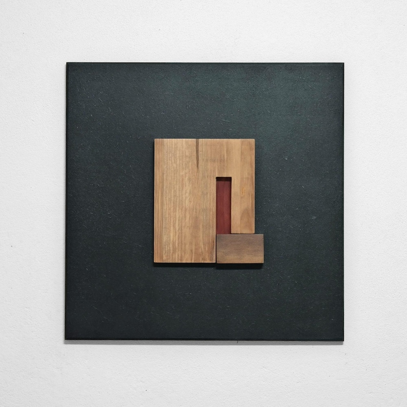 wall art wooden sculpture consisting on a black square frame with colorful geometric elements made of dyed wood