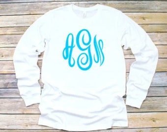 May include: White long-sleeve t-shirt with a blue monogram of the letters AGS.