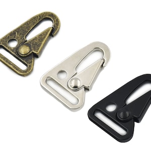 May include: Three metal clasps in different finishes: antique gold, silver, and black. Each clasp has a D-ring and a spring-loaded gate.