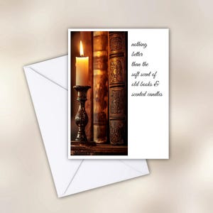 May include: A greeting card with a lit candle in a decorative holder, old books, and the text "nothing better than the soft scent of old books & scented candles." An envelope is in the foreground.
