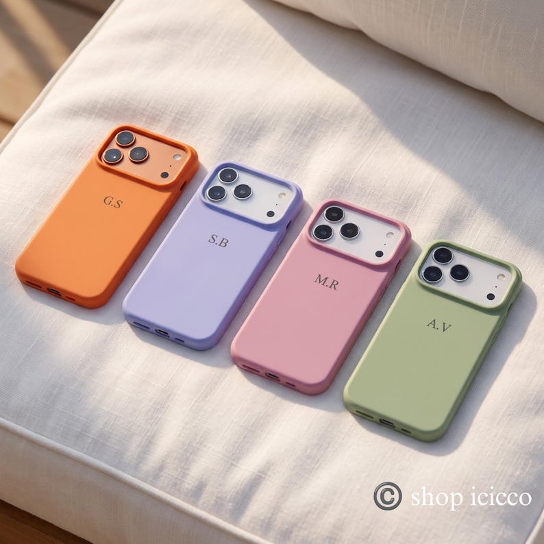 May include: Four smartphone cases in orange, lavender, pink, and sage green. Each case features a camera cutout, a personalized two-letter monogram, and a bottom charging port opening. The text shop icicco is visible in the bottom right corner.