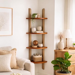 Wooden four tier wall mounted corner shelf styled in a modern livingroom, featuring skincare products, folded towels, woven basket storage and a potted plant