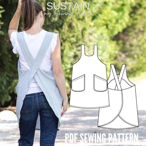 May include: A light blue cross-back apron with two front pockets, shown worn over a white t-shirt and blue jeans, alongside a black and white line drawing illustration of the apron design with the text SUSTAIN my Sewing Habit PDF SEWING PATTERN.