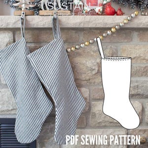 May include: Two hanging Christmas stockings made of dark gray and white striped fabric with a fabric loop at the top. Next to them is a black and white line drawing of a stocking shape. The text at the bottom reads PDF SEWING PATTERN.