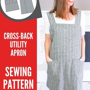 May include: A cross-back utility apron sewing pattern featuring a gray and white vertical striped fabric. The apron has a square neckline, two large front pockets, and a design that crosses in the back. The text reads Cross-Back Utility Apron Sewing Pattern and Sustain my Sewing Habit.