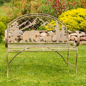 May include: A metal garden bench with a cut-out design of bears and trees. The bench is brown and has a rustic look. It is sitting on a green lawn.