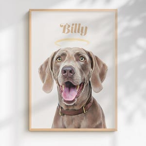 May include: A framed portrait print featuring a brown Weimaraner dog with an open mouth and a pink tongue. Above the dog's head is a golden halo and the name Billy in a cursive font. The dog wears a brown leather collar with gold hardware.