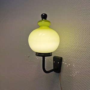 Absolutely stunning wall light, made in black metal frame with olive green glass shade. Danish, retro, vintage, design, Holmegaard