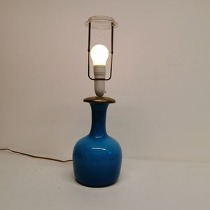 The most beautiful sea blue glass lamp with brass top. Estimated from the 1960s, later rebuilt.