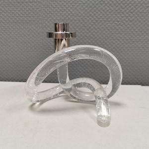 PRETZEL Candleholder by Dorothy Thorpe, 1950s. Twisted and swiveling lucite bases with a chrome holder