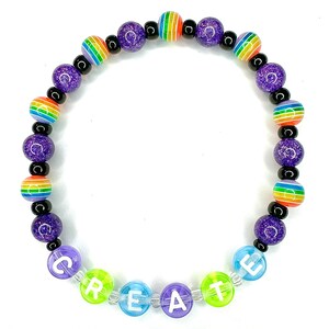May include: A purple and rainbow beaded bracelet with the word "CREATE" spelled out in colorful beads.