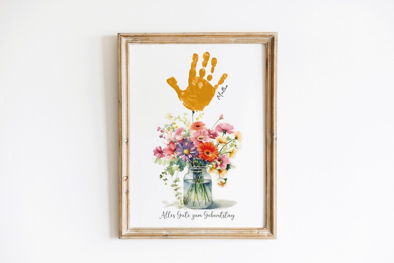May include: A framed print with a yellow handprint, a bouquet of flowers in a glass jar, and the text "Alles Gute zum Geburtstag".