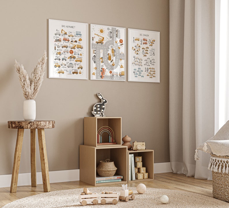 May include: Three framed educational posters with a construction theme for children. The posters feature a colorful alphabet, numbers 1-10, and a road with traffic signs. The posters are displayed on a wall in a nursery or playroom.