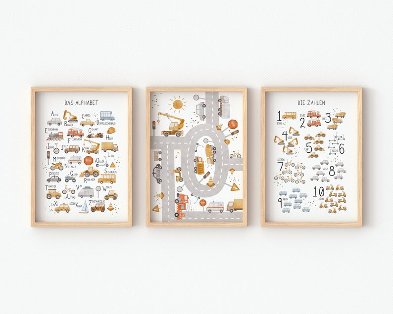 May include: Three framed prints with a light wood frame. The prints feature a colorful illustration of vehicles and transportation. The first print shows the alphabet with each letter paired with a vehicle. The second print shows a circular road with various vehicles. The third print shows numbers 1-10 with each number paired with a vehicle.
