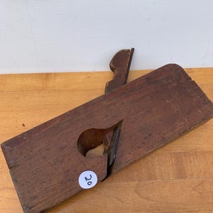 May include: A rustic wooden sign with the text "Welcome to our home" in white lettering. The sign features a distressed finish and a simple, inviting design, perfect for a front porch or entryway.