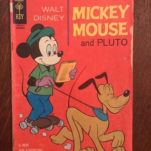 May include: Vintage "Mickey Mouse and Pluto" comic book cover. The cover is red with illustrations of Mickey Mouse on roller skates and Pluto. Text includes "Walt Disney", "Mickey Mouse", and "The Strange World of Gregory Gopher".