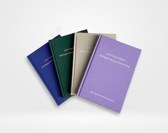 May include: Four different colored journals with the text "Shift Your Energy with Brighter Mornings & Calmer Evenings" on the purple journal. The text "Daily Journal by Internal Glow Up" is printed on the bottom of the purple journal.