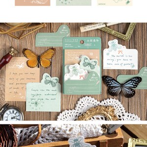 May include: A set of green and white patterned sticky notes with butterfly and bee illustrations. The notes are in a variety of shapes and sizes. The text on the notes includes "Please open it", "The world is too noisy, you have to take care of yourself!" and "Simple like the most long-term, understand your people the most warmth."