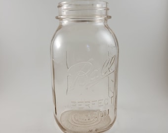 May include: A clear glass Ball jar with the text "Ball Perfect Mason" embossed on the side.