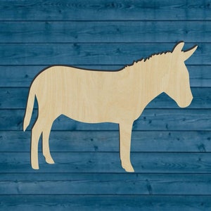 May include: A wooden cutout of a donkey, standing on a blue woodgrain background. The donkey is facing to the right, with its head turned slightly to the left.
