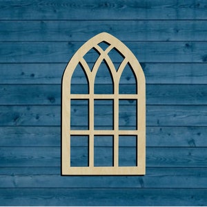 May include: A wooden cutout of a gothic arch window with multiple panes. The window is light brown and is set against a blue wood background.