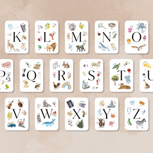 May include: A set of 26 alphabet flash cards with colorful illustrations of objects and animals. Each card features a letter of the alphabet and a variety of images that start with that letter.