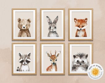 May include: Six framed watercolour prints of woodland animals: a bear, rabbit, fox, raccoon, deer, and hedgehog. Each animal is depicted in soft, natural tones against a neutral background, framed in light wood.