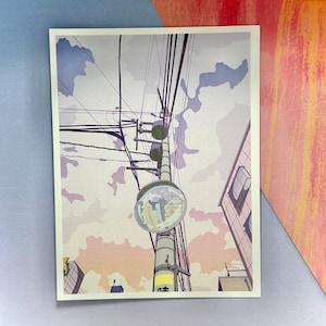 May include: A digital illustration of a street scene with a power pole and wires, a round mirror reflecting the street below, and a building in the background. The sky is a light blue with pink and purple clouds.