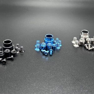 May include: Three sets of screws and washers in black, silver, and blue. Each set includes a larger washer and smaller screws.