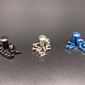 May include: Three sets of screws and bolts, one set is black, one is silver, and one is blue.