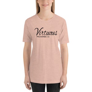May include: A light pink t-shirt with black text that reads "Virtuous Proverbs 31".