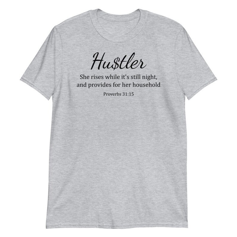 May include: Gray t-shirt with the word "Hustler" in black cursive lettering. The text below reads "She rises while it's still night, and provides for her household Proverbs 31:15".