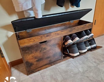 May include: A wooden shoe storage bench with a hinged, padded black top. The bench has a dark brown finish with a drawer and a pull-out shoe rack. Several pairs of shoes are visible on the rack.