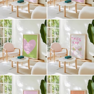 May include: A cozy living room scene featuring a pink armchair, a small white table, and framed art prints. The prints display various phrases and illustrations in pink and white, adding a touch of whimsy to the space. A green plant and a blue box complete the decor.